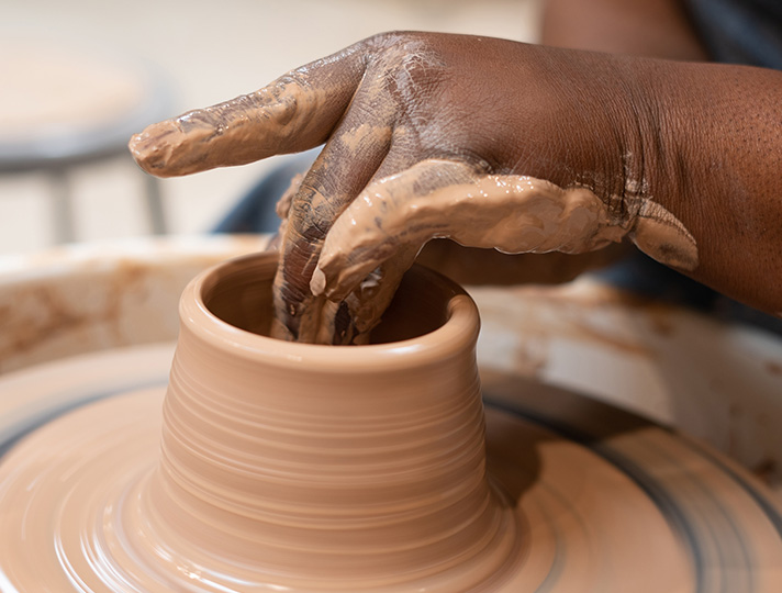 Student learning pottery